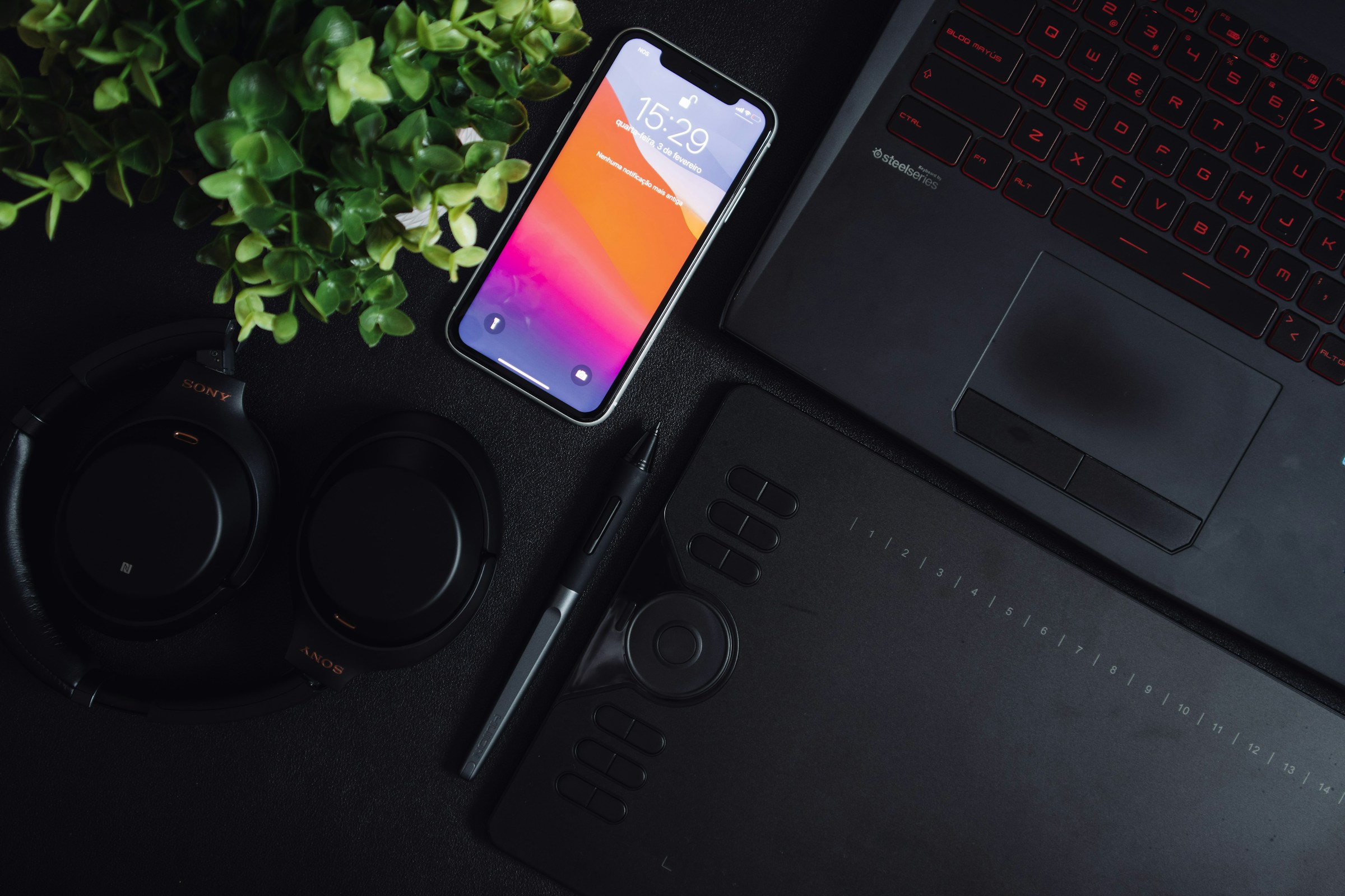 Editorial photo of an iPhone beside a Windows laptop