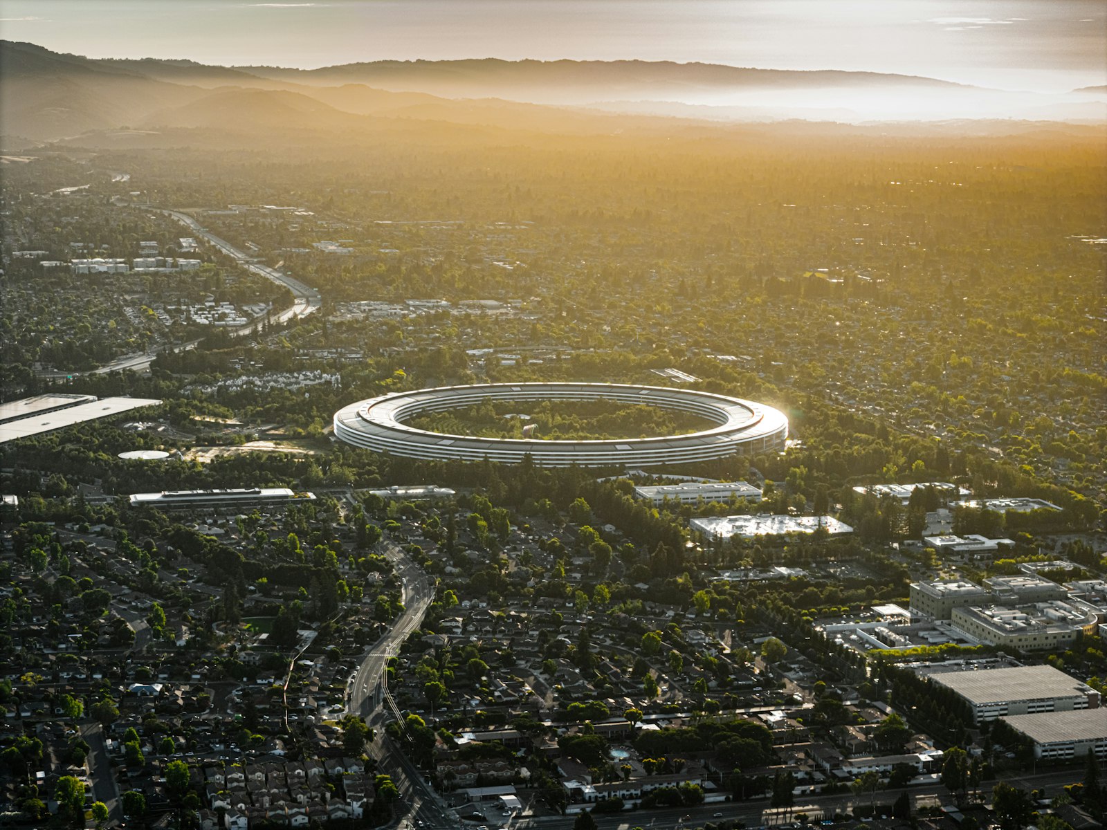 Aerial view of Apple Park in Cupertino at golden hour; contextual photograph of the September event venue, not the unannounced watches